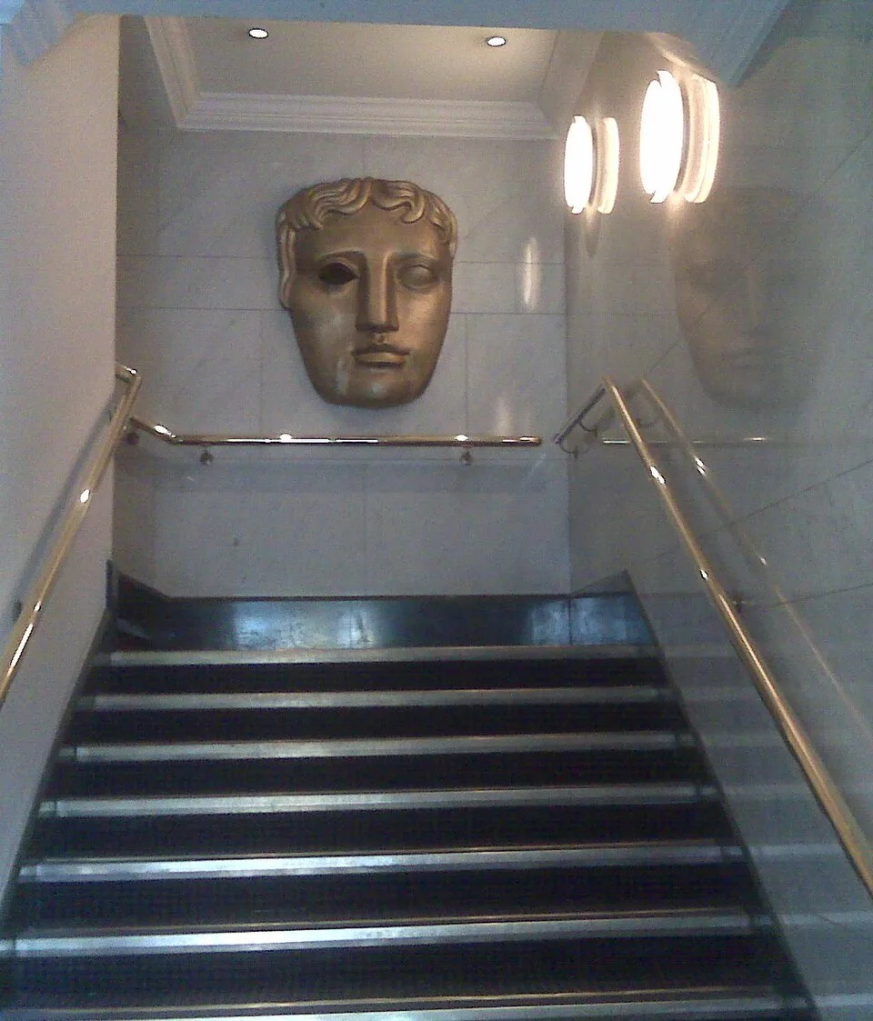 BAFTA mask sculpture at BAFTA headquarters in London—editorial context for Film Awards governance coverage