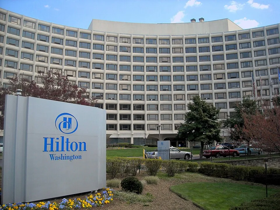 Exterior of the Washington Hilton hotel in Washington, DC — the April 25, 2026 White House Correspondents' Association dinner was held at this venue (Wikimedia Commons, public domain)