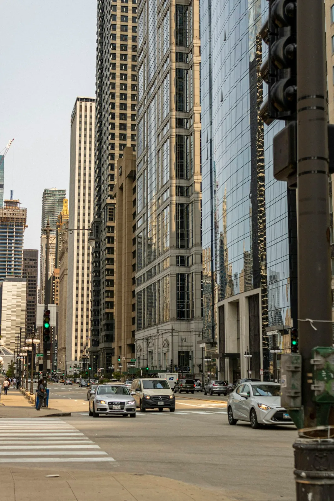 High-rise glass towers of a major financial district seen from street level — illustrative imagery of the global wealth concentration captured by the Forbes 40th annual World's Billionaires List published March 10, 2026, which recorded 3,428 billionaires worth a combined $20.1 trillion.