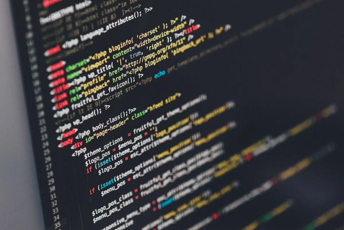 Laptop screen showing code and browser chrome—illustrative imagery for Newsorga’s explainer on reported large background AI model downloads in Google Chrome.