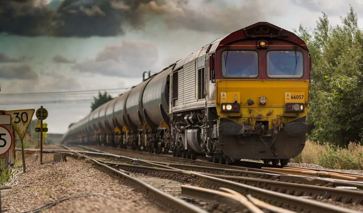 Yellow locomotive and freight cars on railway tracks in daylight — illustrative imagery for reporting on six fatalities discovered inside a Union Pacific boxcar at a Laredo, Texas railyard on Sunday, May 10, 2026.