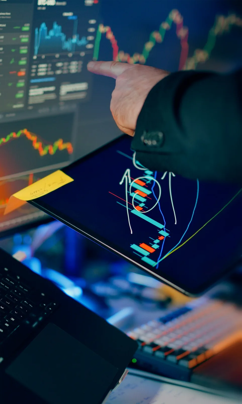 Trader analyzing live stock-market candlestick charts on multiple screens — illustrative imagery of the contrarian-options book Michael Burry disclosed on his Cassandra Unchained Substack on May 4, 2026, doubling his bearish bet on Nvidia, Palantir and the broader AI-trade to roughly $1.1 billion of put-option notional.
