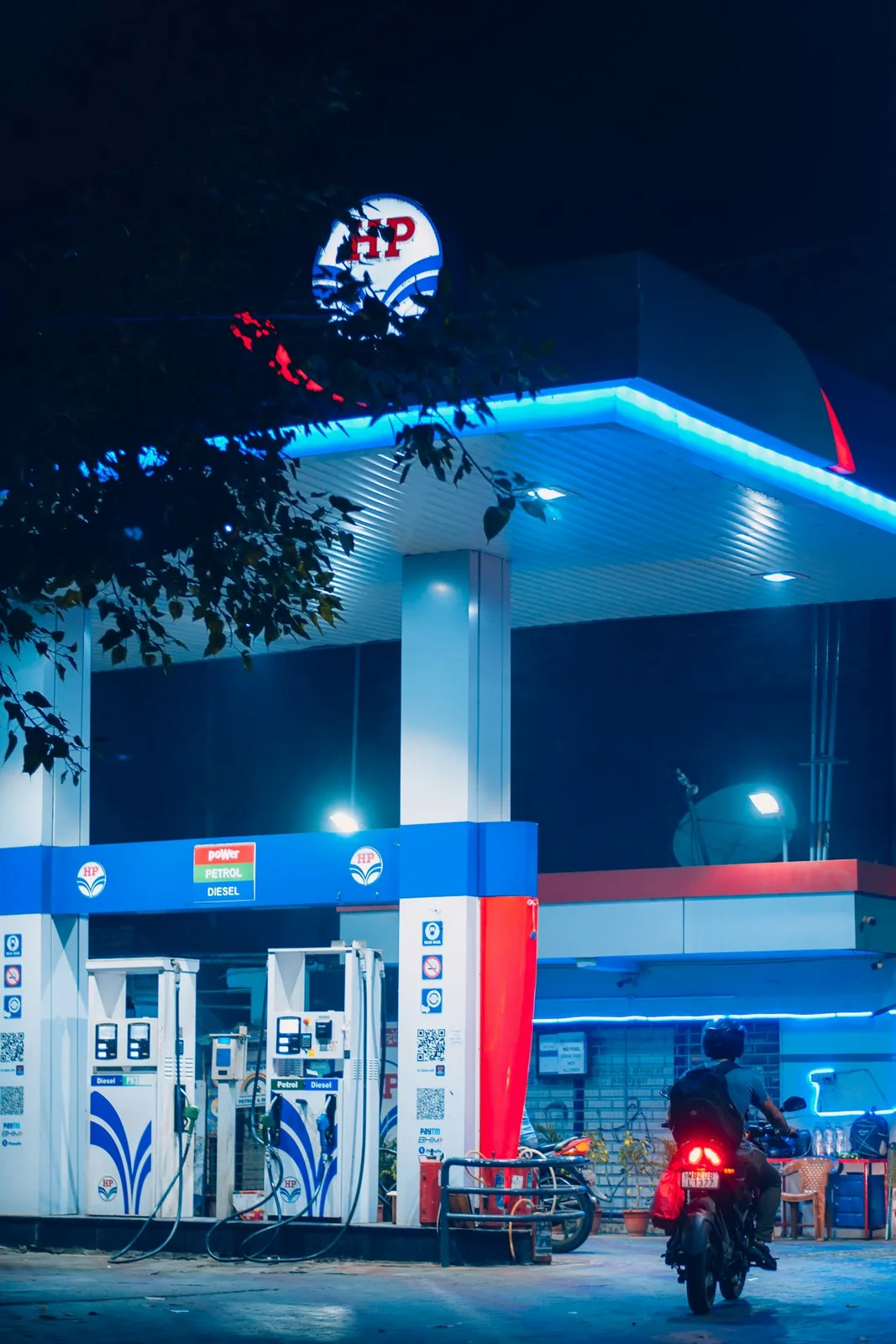 A motorcycle parked at a roadside fuel station under daylight — illustrative imagery for Newsorga's coverage of Prime Minister Narendra Modi's May 10, 2026 appeal to Indians to curb petrol and diesel use amid global energy price pressure and to conserve foreign exchange during the West Asia crisis.