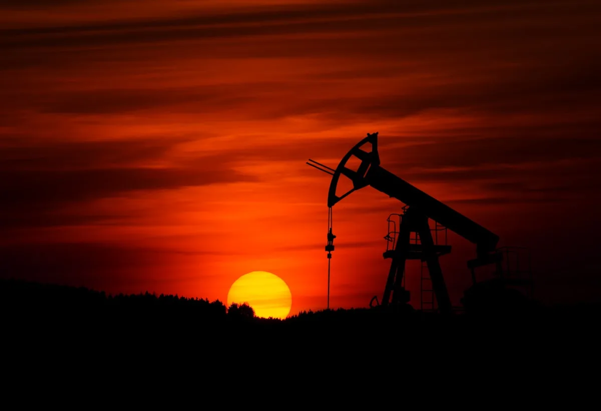 Industrial oil refinery silhouette at sunset — illustrative imagery of the global crude-oil supply chain whose pricing on the Monday May 11, 2026 Asian open jumped roughly three dollars a barrel after Washington's rejection of Iran's ceasefire reply and the continued near-closure of the Strait of Hormuz.