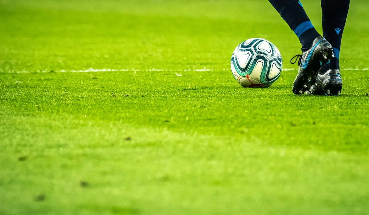 Floodlit football stadium tiers and pitch from the stands—generic Premier League imagery for Newsorga’s analysis of Tottenham Hotspur, Thomas Frank, and Ange Postecoglou; not a club-specific match photo.