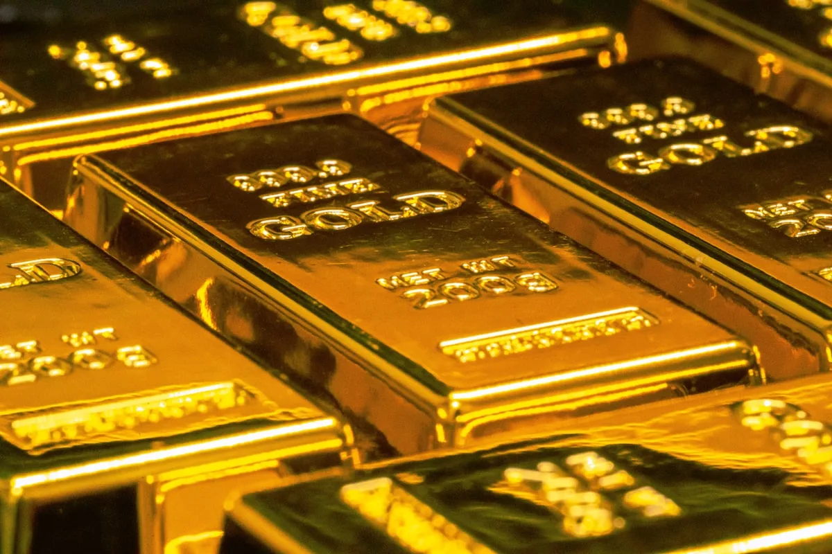 Stacked gold bullion bars under warm overhead lighting — illustrative imagery for Newsorga's coverage of US President Donald Trump's May 10, 2026 Sharyl Attkisson 'Full Measure' interview in which he revived his February 2025 promise to personally audit the United States Bullion Depository at Fort Knox, Kentucky, the underground vault built in 1936 that holds 147,341,858.382 fine troy ounces of gold — about half of the US Treasury's reserves — at a statutory book value of $42.22 per ounce and a market value north of $435 billion at current spot prices.